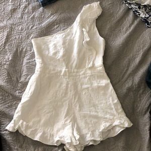 One shoulder white romper.
